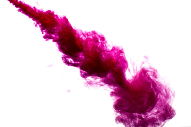 A cloud of red paint is released into the clear water. Isolate on a white background. - Foto, Imagem