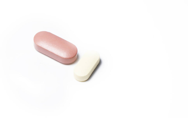 One Brown and one white pill on white background. - Foto, Imagem