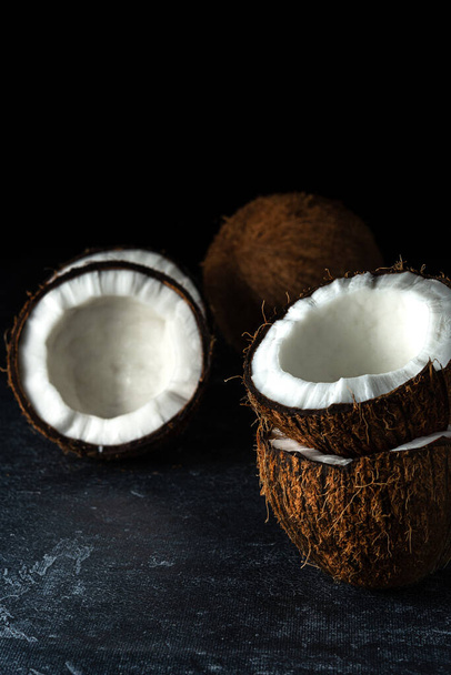 Coconut on a black background - Фото, изображение