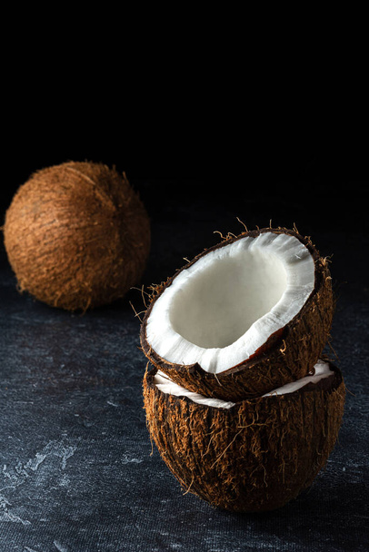 Coconut on a black background - Фото, изображение