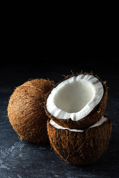 Coconut on a black background - Фото, зображення