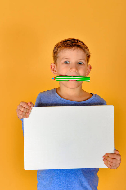 A boy stands with an empty white board an - Photo, Image