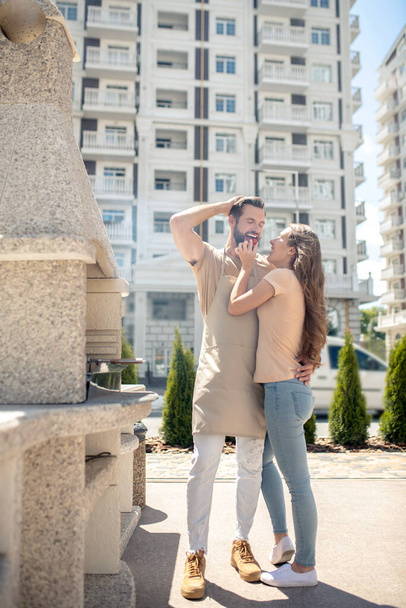 Beautiful couple standing in the yard and hugging - 写真・画像