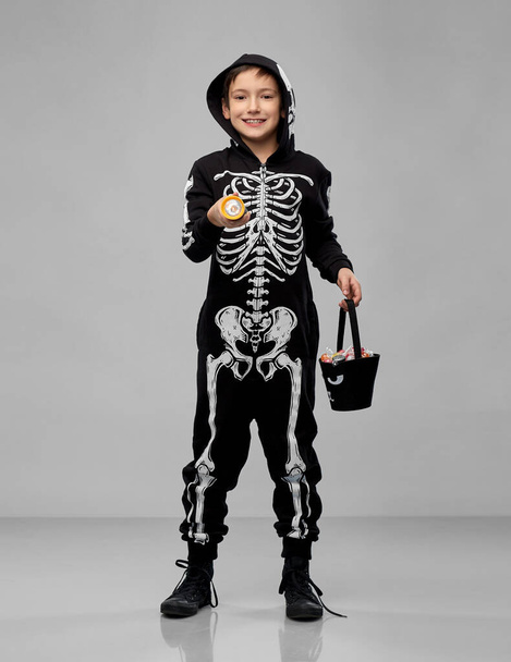 boy with candies and flashlight on halloween - Фото, изображение