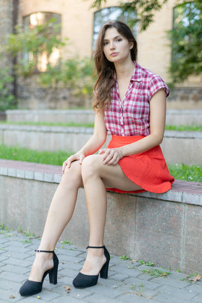Young girl in a red plaid shirt - Foto, imagen