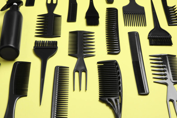 Composition with modern hair combs on yellow background, above view - Fotografie, Obrázek