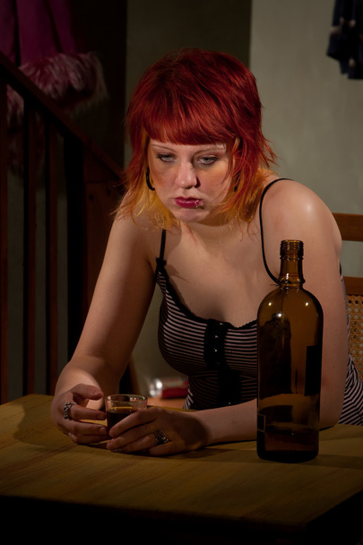 Young woman with near enpty bottle of wine - Foto, afbeelding