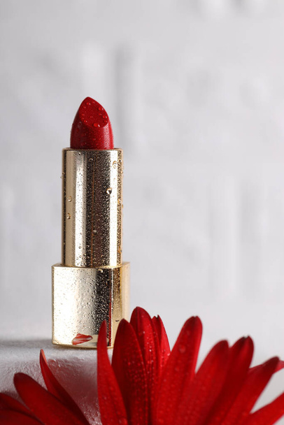 bright red lipstick in a gold tube - Фото, изображение