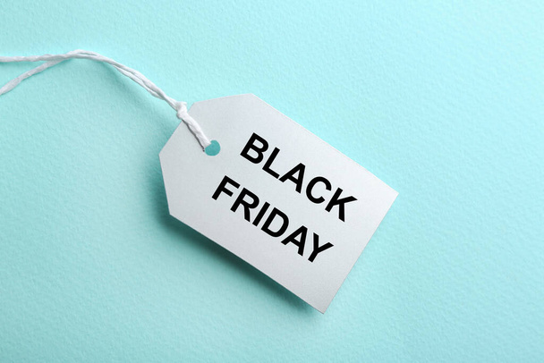 Blank tag on turquoise background, top view. Black Friday concept - Foto, Bild