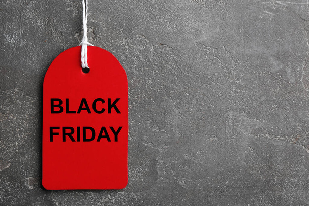 Top view of red blank tag on grey stone background, space for text. Black Friday concept - Φωτογραφία, εικόνα