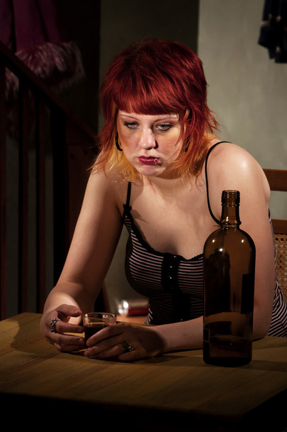 Young woman with near enpty bottle of wine - Foto, afbeelding