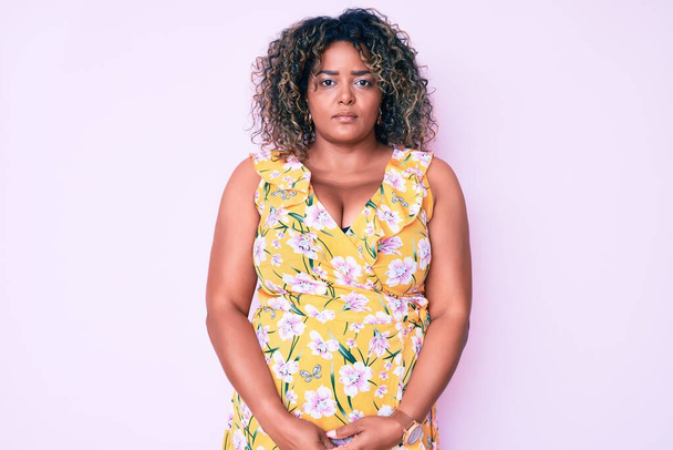 Young african american plus size woman wearing casual clothes with serious expression on face. simple and natural looking at the camera.  - Valokuva, kuva
