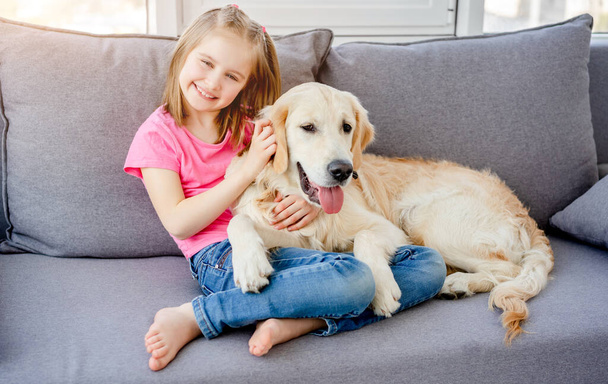 Little girl with golden retriever - Photo, image
