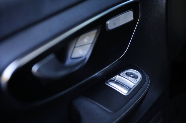 close-up of the side door buttons: window adjustment buttons, door lock. modern car interior: parts, buttons, knobs - Photo, image