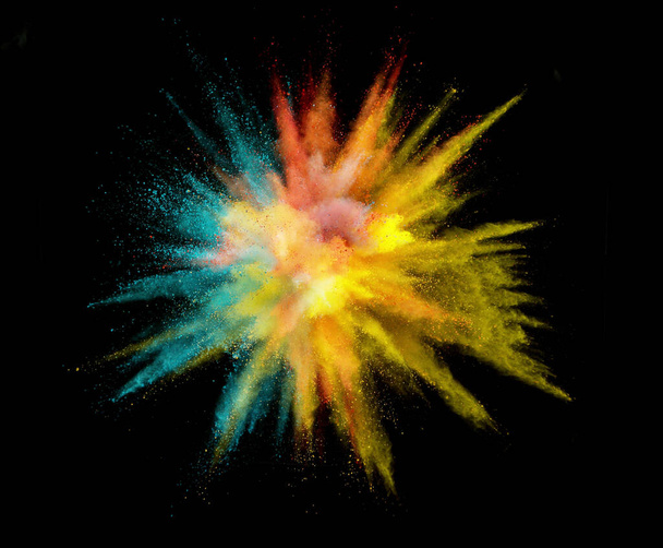Colorful powder explosion isolated on black background, abstract background - Foto, afbeelding