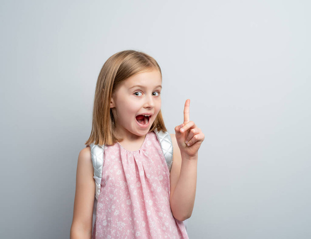 Little girl pointing finger up - Photo, image