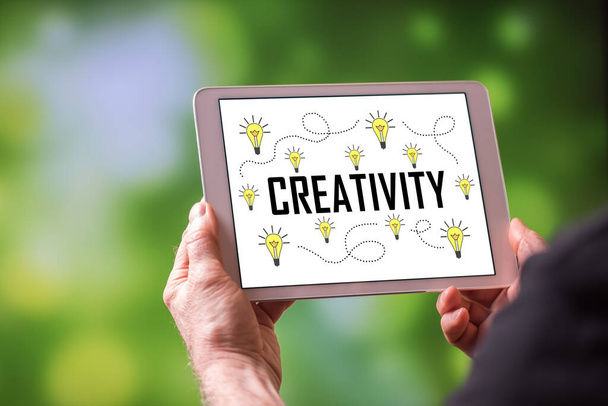 Man holding a tablet showing creativity concept - Foto, Imagen