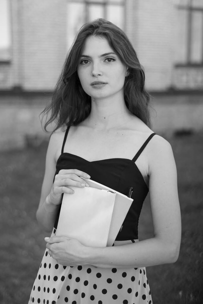 Young girl student in dress. Black and white photo. BW - Фото, изображение
