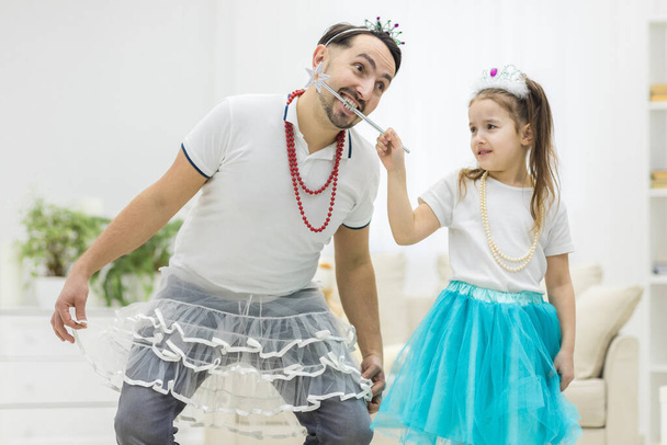 Phot pf handsome young man is dancing at home with his little cute girl. - Photo, Image
