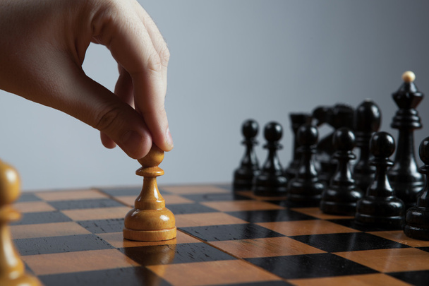 man makes a move chess pawn - Фото, изображение