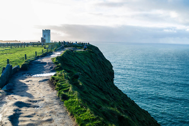 O Briens Tower marks the highest point of the Cliffs of Moher, sea cliffs located at the southwestern edge of the Burren region in County Clare, Ireland - Photo, Image