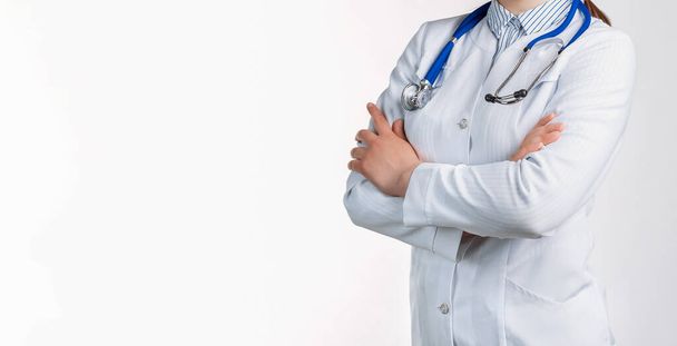 Cropped view of Woman doctor in a white coat with stethoscope. Isolated over white background. Copy space for your text - Foto, imagen