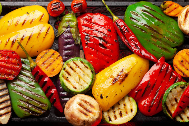 Grilled vegetables cooking on grill with spices and herbs. Top view flat lay - Photo, Image