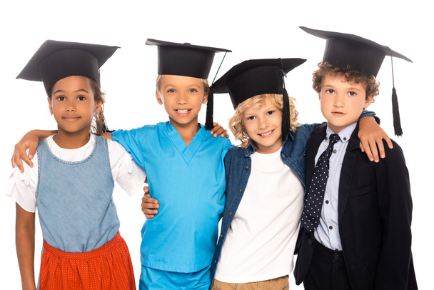 multicultural kids in graduation caps dressed in costumes of different professions isolated on white  - Foto, Imagen