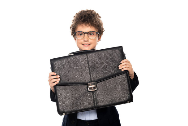 curly boy in suit and glasses holding briefcase isolated on white - Zdjęcie, obraz