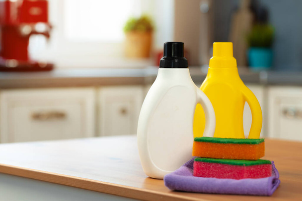 Cleaning detergents and tools on a kitchen counter - Foto, imagen
