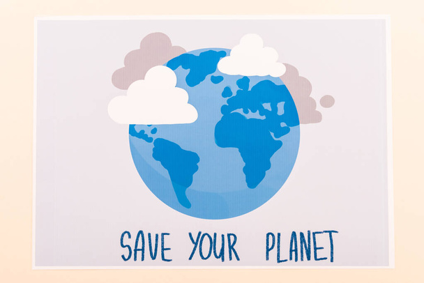 top view of placard with globe and save your planet lettering isolated on beige - Photo, Image