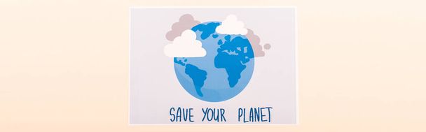 top view of placard with globe and save your planet lettering isolated on beige, panoramic shot - Photo, Image