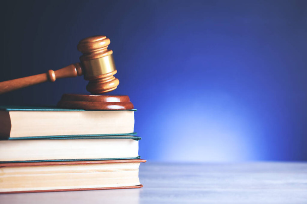 judge on books on blue background - Фото, изображение