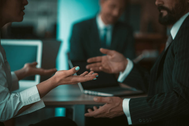 Businessman and businesswoman gesturing with hands while conversation in office - Φωτογραφία, εικόνα