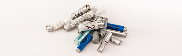 pile of used batteries on white background, panoramic shot - Φωτογραφία, εικόνα