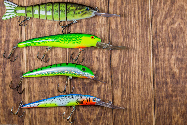 Spinning Lures On Wooden Background - Foto, imagen