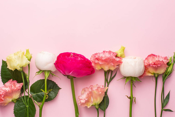 Pink and white flower bouquet on pink background with copyspace top view - Foto, Imagen