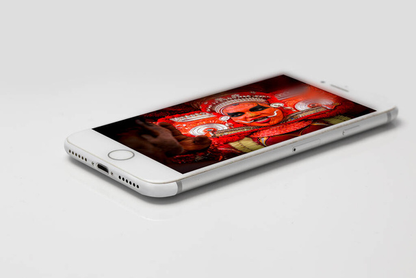 Phone with Theyyam image on it - Photo, Image