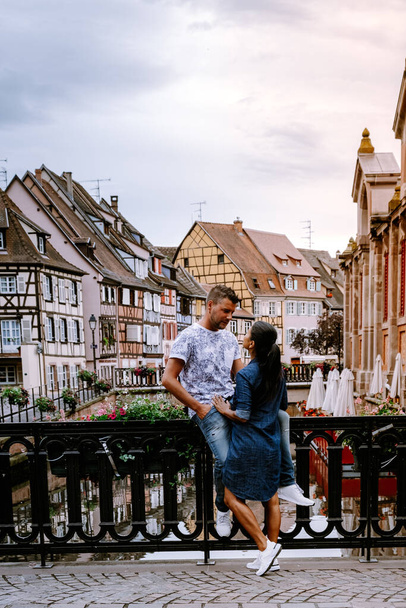 couple on city trip Colmar, Alsace, France. Petite Venice, water canal and traditional half timbered houses. Colmar is a charming town in Alsace, France. Beautiful view of colorful romantic city - Zdjęcie, obraz