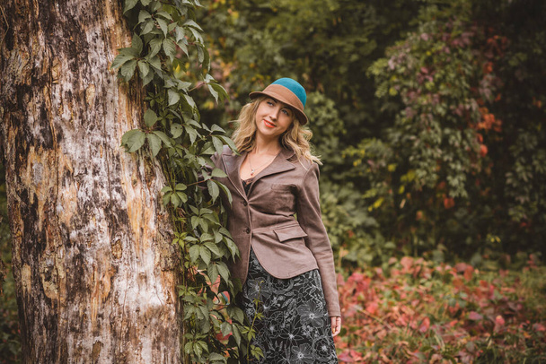 Woman at autumn in fashionable clothes, fashion concept,scene in park with middle aged plus size woman - Photo, Image