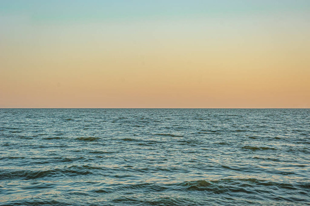 schöne blaue Meereswellen gegen den Himmel bei Sonnenuntergang - Foto, Bild