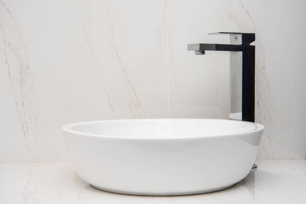 Sink with mixer on a marble base and walls - Photo, Image
