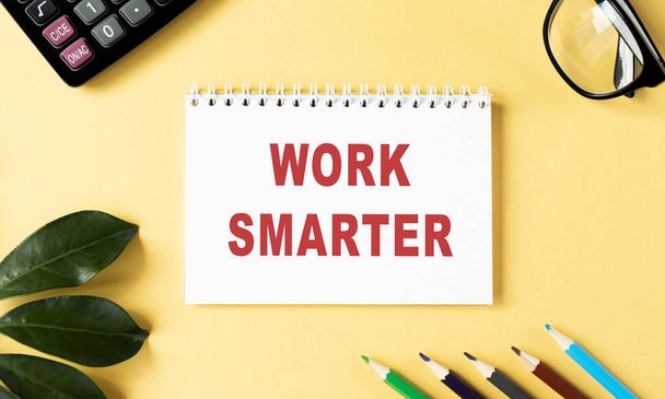WORK SMARTER text written on a notebook with pencils and graphs. - Foto, imagen
