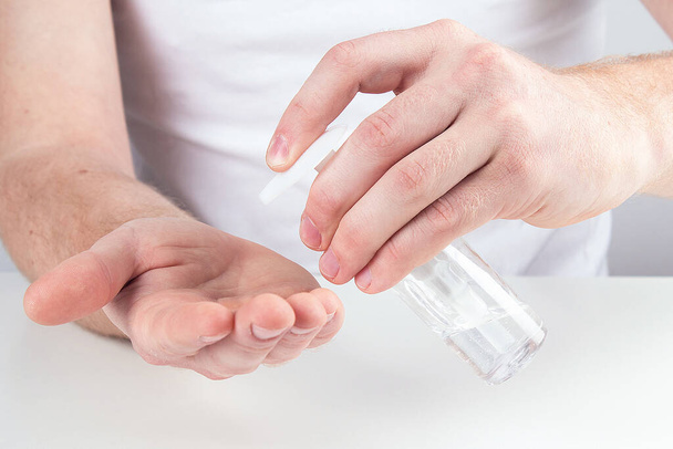 Man person using small portable antibacterial hand sanitizer on the hands. - Foto, Imagem