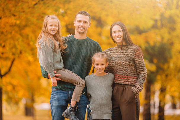 Portrait of happy family of four in autumn day - Photo, Image