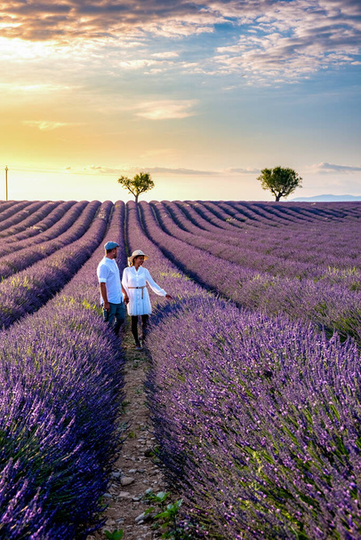 Couple men and woman on vacation at the provence lavender fields, Provence, Lavender field France, Valensole Plateau, colorful field of Lavender Valensole Plateau, Provence, Southern France. Lavender - Photo, Image