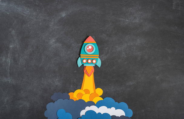 Rocket takes off paper craft. Back to school. Copy space. Black background school board. Business concept - Valokuva, kuva