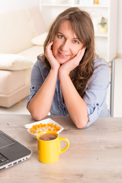 Woman eating breakfast at home - Photo, Image