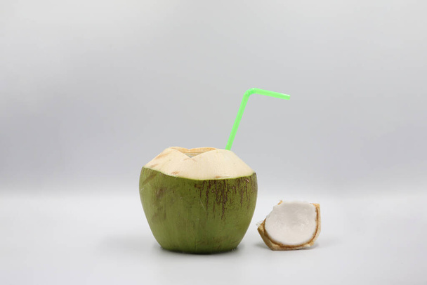 Свежий зеленый кокос с изоляцией соломы. Концепция летнего напитка на белом фоне. - Фото, изображение