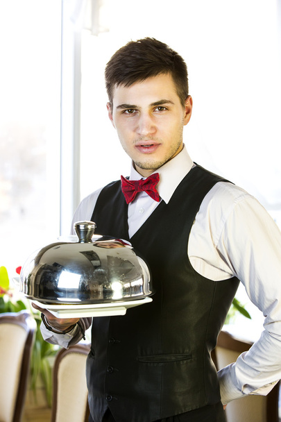Waiter with a tray of food - 写真・画像
